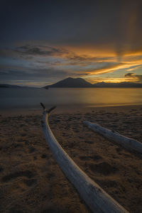 Scenic view of beach against sky during sunset