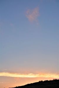 Low angle view of silhouette landscape against sky at sunset