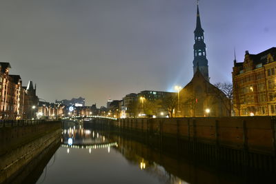 Reflection of illuminated buildings in water at night