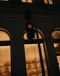 Low angle view of silhouette man standing against building