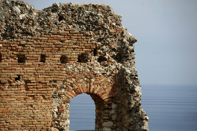 Old ruins of building against sea