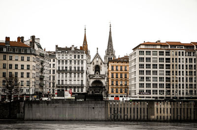 View of buildings in city against clear sky