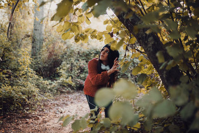 Woman walking through the forest during the day