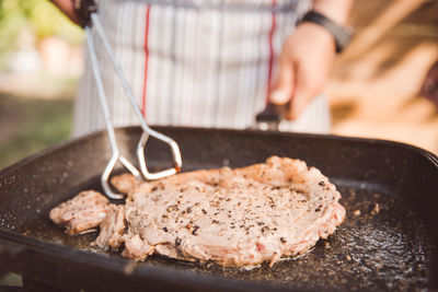 Close-up of man preparing meat