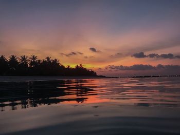 Scenic view of sea against orange sky