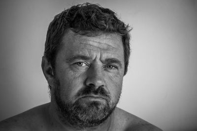 Close-up portrait of man against white background