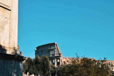 Low angle view of old building against clear blue sky