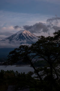 Scenic view of snowcapped mountain against cloudy sky