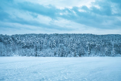 Snow covered landscape against sky