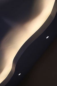 Low angle view of silhouette airplane against sky at night
