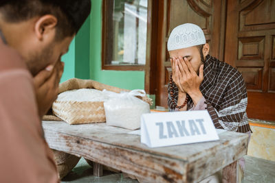 Young men praying together in mosque