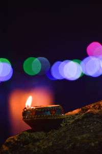 Close-up of lit candles against blurred background