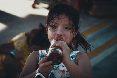 Full length portrait of a girl drinking glass