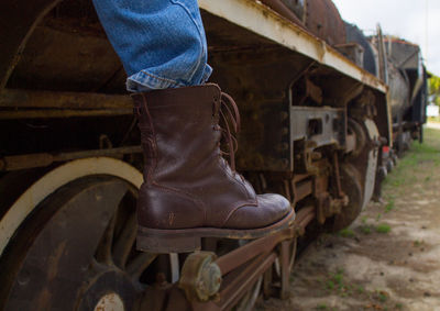 Low section of a woman standing by train