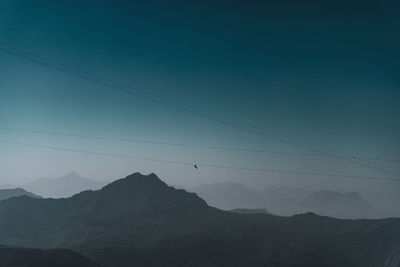 Low angle view of silhouette mountains against sky at dusk