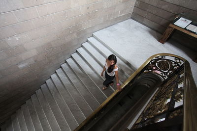 High angle view of young woman walking on steps 