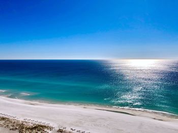 Scenic view of sea against clear blue sky