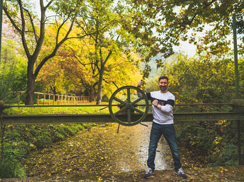 Rear view of man standing by trees