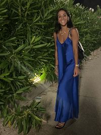 Portrait of a smiling young woman standing outdoors