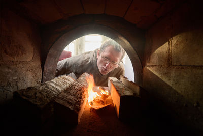 Low angle view of man standing in tunnel