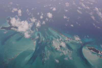 Aerial view of sea against cloudy sky
