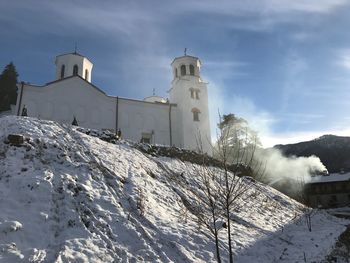 Low angle view of church against sky during winter