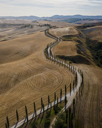 High angle view of road by land against sky