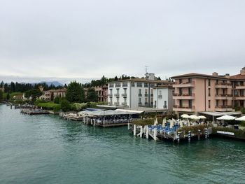 Sirmione, italy. turquoise blue water. beautiful colorful buildings around. reflection in water. 