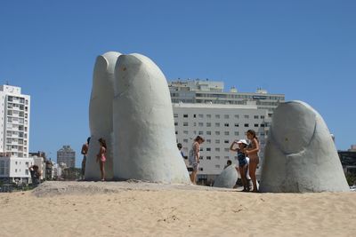 Statue of people on sand