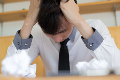 Businessman sitting with head in hands