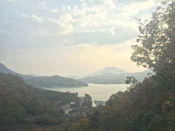 Scenic view of lake against cloudy sky