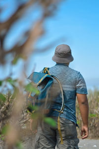 Rear view of people walking on land