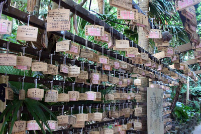 Full frame shot of bottles hanging on building