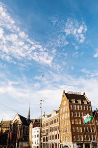 Low angle view of buildings in town against sky