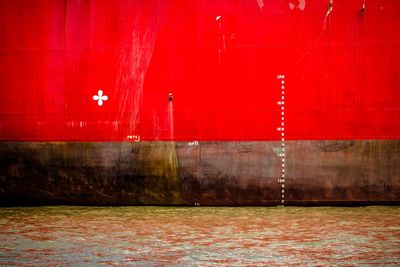 Red wall with building in background