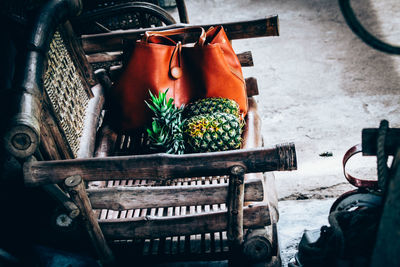 Pineapple and brown purse on chair