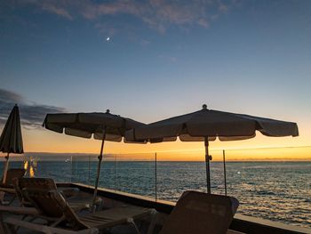 Scenic view of beach against sky during sunset