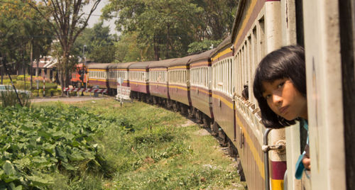 Rear view of woman looking at train