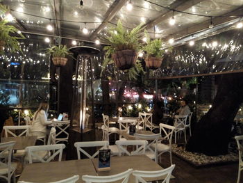 Chairs and tables in cafe at night