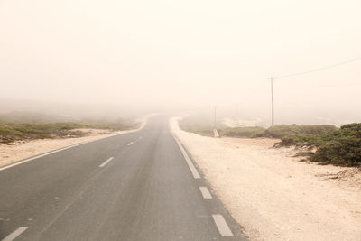 Country road against sky