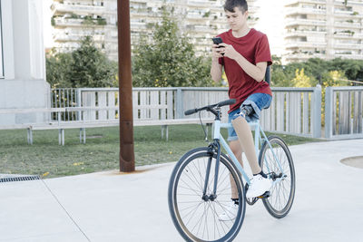 Disabled cyclist using phone on street