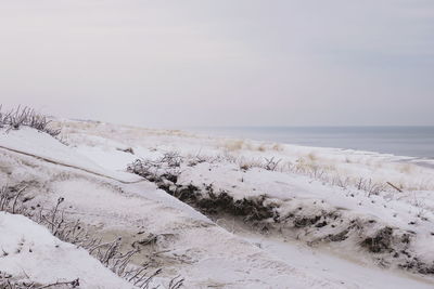 Scenic view of sea against sky during winter