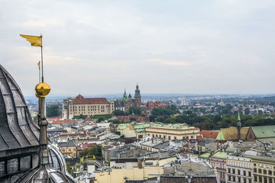 Aerial view of city by sea against sky