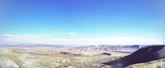 Scenic view of landscape against blue sky