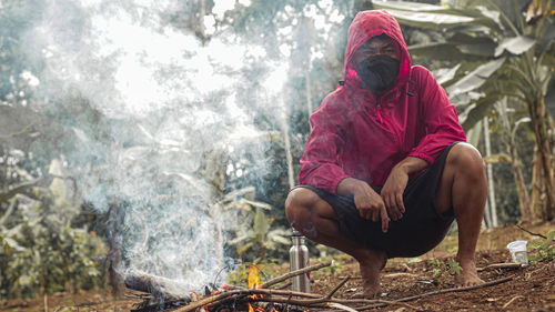 Rear view of man working in forest