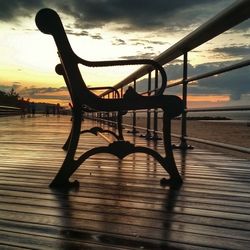 People on pier at sunset