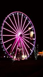 Low angle view of illuminated lights at night