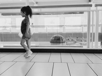 Girl looking through window at home