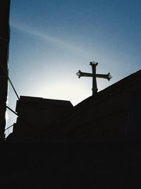 Low angle view of cross against sky