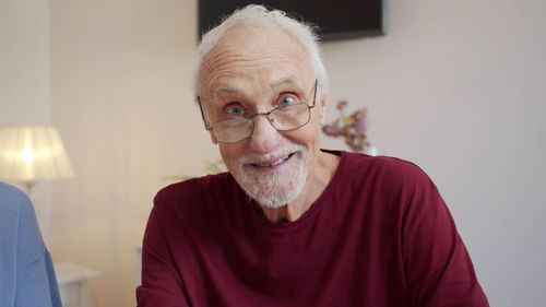 Portrait of young man sitting at home